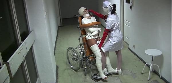  Patient in Wheelchair with Broken Legs and Straitjacket - TheWhiteWard.com
